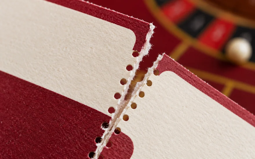 The torn edge of a perforated voucher photographed in close detail