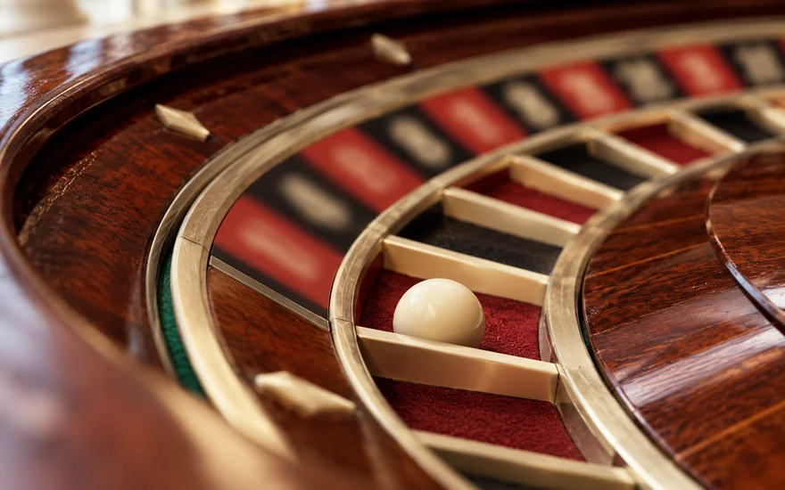 The ball and pocket separators of a wooden roulette wheel
