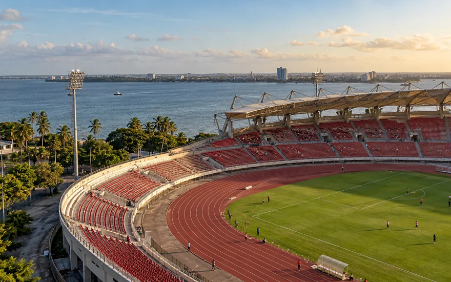 An elevated view across the running track and seating of a coastal football stadium