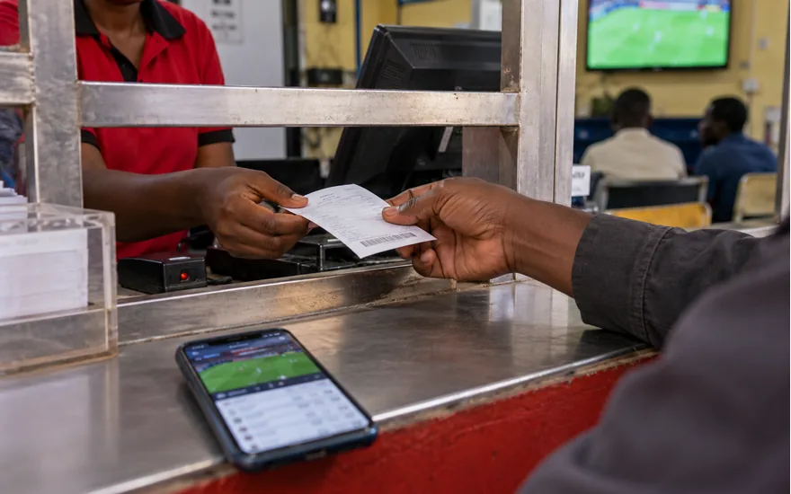 A customer hands a transaction receipt through a local payment service opening