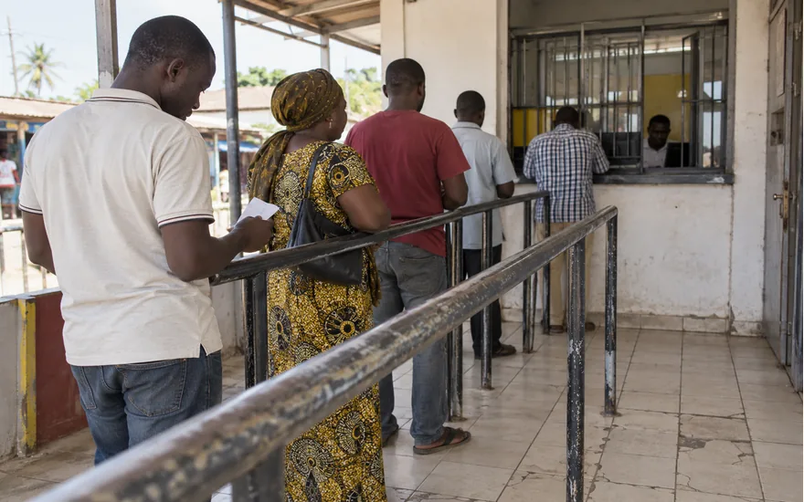 Queue rails lead towards a small Tanzanian mobile money service window